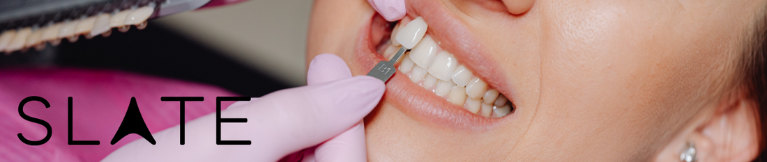 Woman having a veneer placed on her teeth. Slate logo included