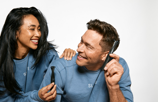 man and woman smiling at each other holding Slate flossers