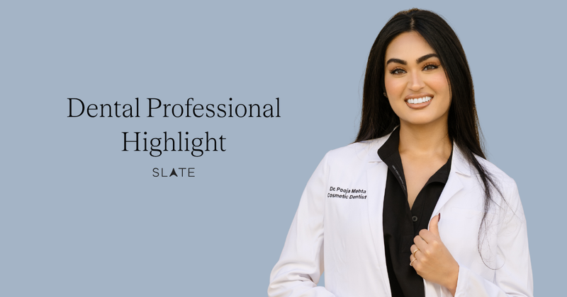 Woman with dark hair and a white lab coat smiling